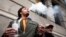 A man smokes as he waits in line for the opening of the Quebec Cannabis Society (SQDC) store, on the day Canada legalizes recreational marijuana, in Montreal, Quebec, Canada, Oct. 17, 2018. 
