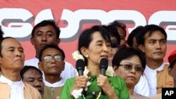 Burma's pro-democracy icon Aung San Suu Kyi talks to supporters at a stadium on her arrival at Pathein, Pathein, Irrawaddy delta, Feb. 7, 2012.