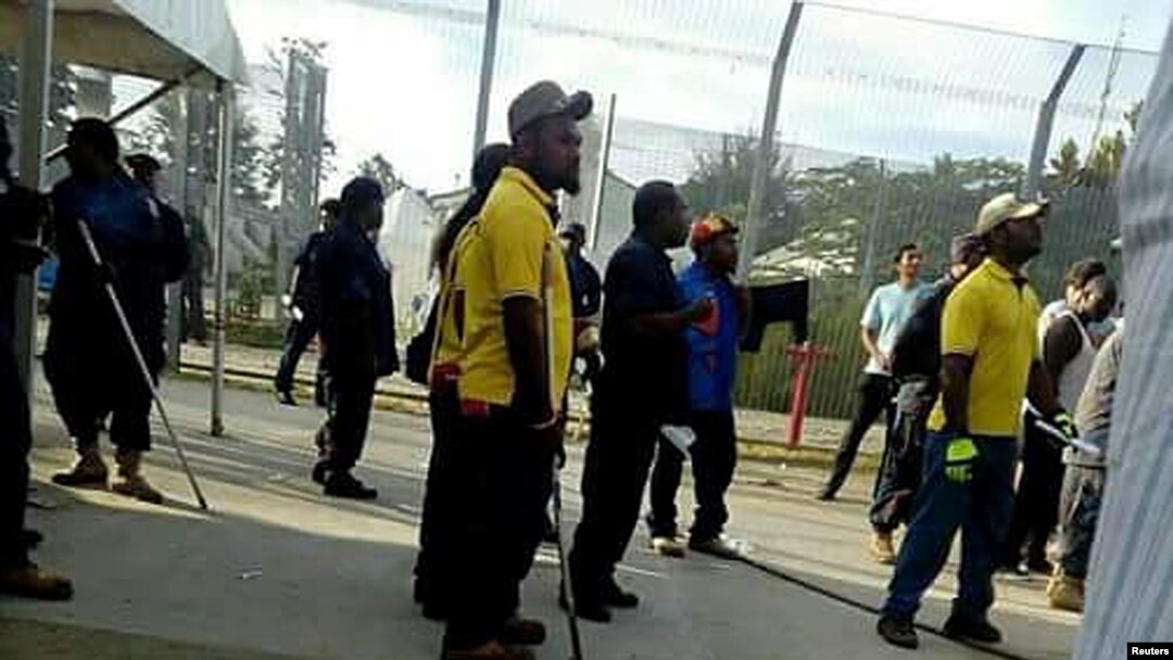 Papua New Guinean police officers enter the Manus Island immigration detention center in Papua New Guinea, Nov. 23, 2017.