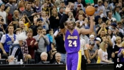 FILE - Los Angeles Lakers guard Kobe Bryant (24) holds up the game ball and acknowledges the crowd during an NBA basketball game against the Minnesota Timberwolves after passing Michael Jordan on the NBA all-time scoring list, in Minneapolis, Dec. 14, 2014.