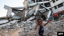 A girl stands on September 17, 2024 at a school destroyed by Israeli strikes in Khan Yunis in the southern Gaza Strip, amid the ongoing war between Israel and the Hamas militant group.