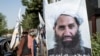 FILE - A poster of Taliban Supreme Leader Hibatullah Akhundzada is seen along a road in Kabul on Aug. 14, 2023. The International Criminal Court is seeking arrest warrants for Akhundzada and his chief justice.