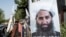 FILE - A poster of Taliban Supreme Leader Hibatullah Akhundzada is seen along a road in Kabul, Aug. 14, 2023. ICC chief prosecutor’s announced, Jan. 23, 2025, seeking arrest warrants for Akhundzada and a close associate accused of crimes against humanity.
