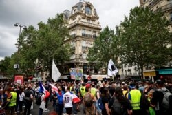 Protesters attend a demonstration called by the "yellow vest" movement against France's restrictions, including a compulsory health pass, to fight the COVID-19 outbreak, in Paris, July 31, 2021.