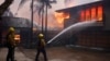 Firefighters hose down flames as the Palisades Fire reaches a residence in the Pacific Palisades neighborhood of Los Angeles, Jan. 7, 2025. 