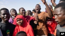 FILE - Young people gather to register to volunteer to fight for the country as part of a volunteer initiative, in Niamey, Niger, on Aug. 19, 2023. Families in Niger say they are struggling as neighboring countries have closed their borders with Niger, stymying livestock trade.