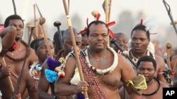 FILE - In this Monday Sept. 3, 2012 file photo Eswatini's King, Mswati III, front, dances during a Reed Dance in Mbabane.