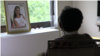 Selamawit Tefera sits by a window in this still frame from a video captured on Aug. 3, 2018. In February, Selamawit, an Ethiopian immigrant, was attacked by her roommate in Maryland. (Karina Choudhury/VOA News)