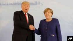 U.S. President Donald Trump and German Chancellor Angela Merkel pose for a photograph before a bilateral meeting on the eve of the G-20 summit in Hamburg, Germany, July 6, 2017. The leaders of the Group of 20 meet Friday and Saturday.