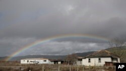 A rainbow is seen over a flooded landscape, Jan. 11, 2017, in Hollister, Calif. 