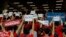 FILE - Hong Kong soccer fans turn their backs and boo the Chinese national anthem as they chant "Hong Kong is not China" during a World Cup qualifying soccer match between Hong Kong and Iran, in Hong Kong, Sept. 10, 2019. 
