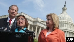 Human trafficking survivor Shandra Woworuntu (C) speaks during a news conference with Rep. Ted Poe (L) and Rep. Carolyn Maloney outside the U.S. Capitol May 20, 2014.
