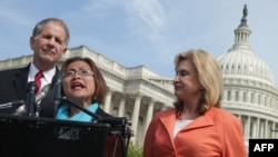 Human trafficking survivor Shandra Woworuntu (C) speaks during a news conference with U.S. House of Representatives Victims' Rights Caucus Chairman Rep. Ted Poe (L) and Rep. Carolyn Maloney outside the U.S. Capitol May 20, 2014 in Washington, DC.