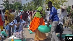 FILE - Somali internally displaced people receive food aid donated by a Qatari charity during the holy Muslim month of Ramadan in Mogadishu, June 20, 2015. Somalia's federal government has said it will stay neutral in Qatar's dispute with other Gulf Arab states.