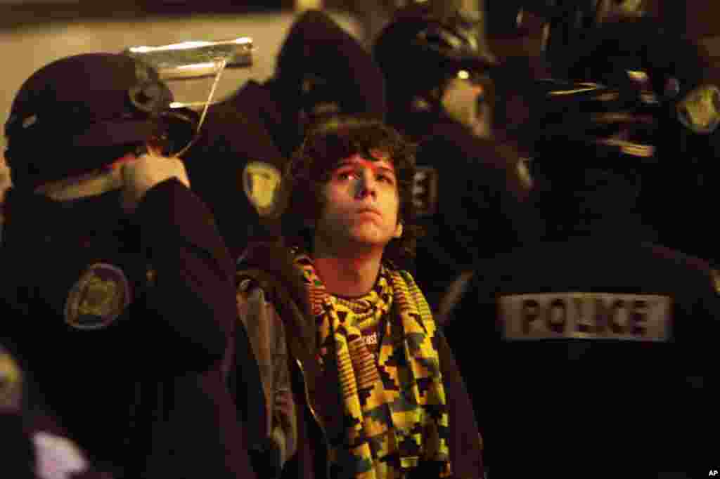 A demonstrator just after being arrested for blocking the entrance to Terminal 18 of the Port of Seattle, Washington. (Reuters/Robert Sorbo)