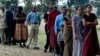 FILE - Members of a Kenyan family of Asian origin stand in line to cast their vote in Nairobi, Kenya, Dec. 27, 2007. On July 21, Kenya officially recognized Kenyan nationals of Asian descent as the country's 44th tribe. 