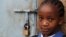 A girl stands next to her locked classroom as a nationwide strike by Kenyan teachers demanding a salary increase left most learning institution paralyzed, in Nairobi, September 5, 2012. 