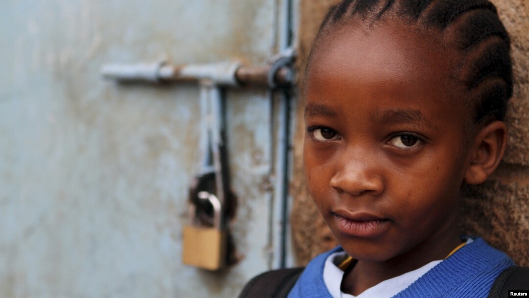 A girl stands next to her locked classroom as a nationwide strike by Kenyan teachers demanding a salary increase left most learning institution paralyzed, in Nairobi, September 5, 2012. 