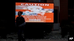 FILE - A sign cautioning against fentanyl is displayed on a screen outside the Lummi Nation tribal headquarters, near Bellingham, Washington, Feb. 8, 2024.