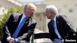 FILE - President Donald Trump speaks with Attorney General Jeff Sessions as they attend the National Peace Officers Memorial Service on the West Lawn of the U.S. Capitol in Washington, U.S.