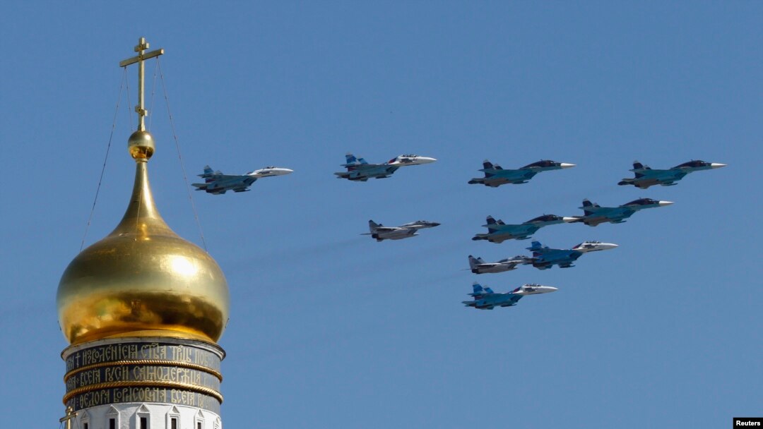 FILE - Russian military planes fly above the Kremlin.