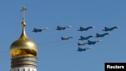 FILE - Russian military planes fly above the Kremlin.