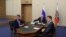 FILE - Russian President Vladimir Putin, center, then-Deputy Prime Minister of Russia Dmitry Kozak, left, are seen participating in a video conference in Sochi, Russia, Dec. 2, 2019. At right is Russian Energy Minister Alexander Novak.