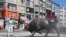 Workers clean and disinfect one of the city's iconic landmarks, the Bull, in Kadikoy Square amid the coronavirus outbreak, in Istanbul, April 12, 2020.