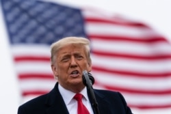 President Donald Trump speaks near a section of the U.S.-Mexico border wall, Tuesday, Jan. 12, 2021, in Alamo, Texas. (AP Photo/Alex Brandon)