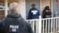 FILE - In this Feb. 9, 2017, photo provided U.S. Immigration and Customs Enforcement, ICE agents are at a home in Atlanta, Georgia, during a targeted enforcement operation aimed at immigration fugitives, re-entrants and at-large criminal aliens.