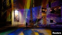 FILE - Passersby walk toward Leopold Museum, Vienna, Oct. 30, 2013.