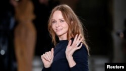 FILE - British designer Stella McCartney appears at the end of her Fall/Winter 2017-2018 women's ready-to-wear collection show during Paris Fashion Week, in Paris, March 6, 2017. Last year, McCartney became the first designer to sign up with the Make Fashion Circular initiative, which aims to eliminate waste and pollution and ensure products and materials are reused.