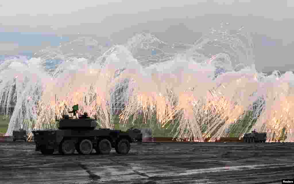 Japanese Ground Self-Defense Force tanks and other armored vehicles take part in an annual training session near Mount Fuji at Higashifuji training field in Gotemba, west of Tokyo.