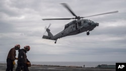 In this photo provided by the U.S. Navy, an MH-60S Sea Hawk lands on the flight deck of the Nimitz-class aircraft carrier USS Theodore Roosevelt during exercise Freedom Edge on June 28, 2024.
