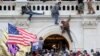 FILE - A mob of supporters of U.S. President Donald Trump fight with members of law enforcement at a door they broke open as they storm the U.S. Capitol Building in Washington, Jan. 6, 2021. 