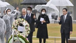 Japanese Prime Minister Fumio Kishida and U.S. Ambassador to Japan Rahm Emanuel visit Hiroshima's Peace Memorial Park on March 26, 2022. (Kyodo News via Reuters)