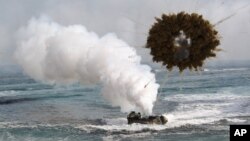 FILE - The 2015 Livelihood Award honors the Marshall Islands prime minister and people for suing nuclear powers over their failure to disarm. Shown here is a South Korean marine LVT-7 landing craft sailing through a smoke screen during joint U.S.-South Ko