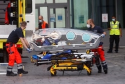 FILE - German army emergency personnel load into their ambulance the stretcher that was used to transport Russian opposition figure Alexei Navalny on at Berlin's Charite hospital, Aug. 22, 2020.