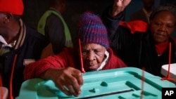 FILE: Lydia Gathoni Kiingati, 102, casts her vote just after dawn at a polling station in Gatundu, north of Nairobi, Kenya. Taken 8.8.2017