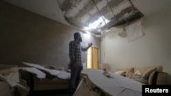 سعودی عرب کے دارالحکومت ریاض میں ایک سعودی شہری یمن کے حوثی باغیوں کے میزائل حملے میں اپنے گھر کو پہنچنے والا نقصان دکھا رہے ہیں۔ (فائل فوٹو)