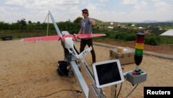 A Zipline engineer prepares a a drone for test flight at an operations base in Muhanda, south of Rwanda's capital, Kigali. Zipline, a California-based robotics company, delivered its first blood to patients using a drone, Oct. 12, 2016.