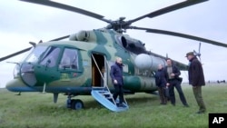 In this photo taken from video released by Russian TV Pool on April 18, 2023, Russian President Vladimir Putin arrives at an undisclosed location. The Kremlin says Putin has visited headquarters of the Russian troops fighting in Ukraine.