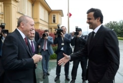 FILE - Turkey's President Recep Tayyip Erdogan, left, welcomes Qatar's Emir Sheikh Tamim bin Hamad Al Thani before their talks in Istanbul, Nov. 26, 2018.