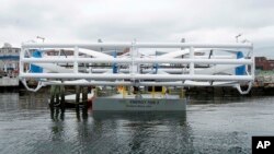 FILE - The Energy Tide 2, the largest tidal energy turbine ever deployed in the U.S., appears on a barge in Portland, Maine. 