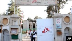 FILE - Christopher Stokes, the general director of medical charity Doctors Without Borders, stands at the gate of the organization's hospital, after it was hit by a U.S. airstrike, in Kunduz, Afghanistan, Oct. 15, 2015.