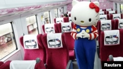 FILE - A performer dressed as a Hello Kitty poses inside a Hello Kitty-themed Taroko Express train in Taipei, Taiwan, March 21, 2016. 