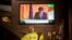 People in a bar watch the speech of Catalan regional president Carles Puigdemont on television in Barcelona, Spain, Oct. 26, 2017.