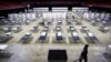 FILE - A worker moves items at a Federal Medical Station for hospital surge capacity set up at Temple University's Liacouras Center in Philadelphia, March 30, 2020.