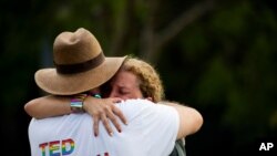 Rep. Debbie Wasserman Schultz, D-Fla., is comforted after a truck drove into a crowd of people during The Stonewall Pride Parade and Street Festival in Wilton Manors, Fla., June 19, 2021. 