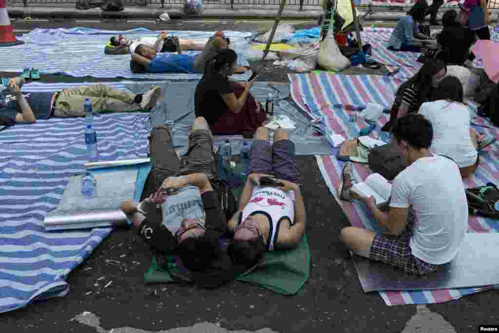 Protesters of the Occupy Central movement rest under a tent on a main road at the Mong Kok shopping district in Hong Kong, Oct. 6, 2014.